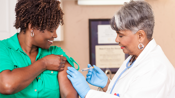 Nurse giving an injection to female